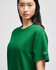 A green Champion adult short-sleeve T-shirt featuring a logo on the sleeve.