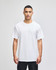 A white short-sleeve t-shirt worn by a model, featuring a simple design and a logo.