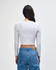 A grey long-sleeve cropped fitted T-shirt with a simple design and a logo on the back, paired with blue jeans.