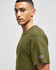 An olive green short sleeve T-shirt with a logo on the sleeve, displayed on a model.