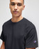 A black Champion adult jersey short sleeve T-shirt featuring a subtle logo on the sleeve.