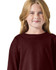 A maroon long sleeve t-shirt featuring a round neck, modelled by a child with long blonde hair, showcasing a logo.