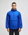 A blue packable anorak jacket with a hood and front pocket, featuring a logo on the sleeve.