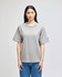 A grey Champion Adult Heritage Jersey T-Shirt on a model, featuring a relaxed fit and short sleeves.