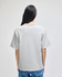 A grey Champion Adult Heritage Jersey T-Shirt viewed from the back, featuring a relaxed fit and short sleeves.