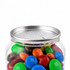 A clear canister filled with M&M's in various colours, including red, blue, green, yellow, and orange, with a metal lid.
