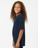 A navy blue youth T-shirt with short sleeves, featuring a logo on the back. The model smiles with curly hair.