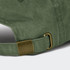 A vintage washed green cap featuring a metal buckle and adjustable strap at the back.