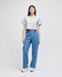 A grey cropped short sleeve t-shirt paired with blue jeans, worn by a model against a plain background.