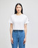 A cropped white T-shirt with short sleeves and a logo on the sleeve, paired with blue jeans.