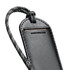 A black luggage tag with a textured surface and a patterned strap, featuring a branding logo.