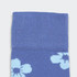 Knee-high socks in a blue hue featuring floral patterns, with a textured upper section and a smooth lower section.