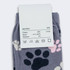 Jolly knitted kids' socks in grey with colourful paw prints, featuring a label with material and size information.