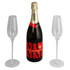 A champagne bottle with two clear flutes, featuring red and gold branding, in a sleek presentation.