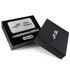 A sleek silver pen, USB drive, and a metallic card in a black gift box with a logo.