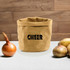 A kraft paper storage bag in tan, featuring a logo, next to an onion and several potatoes on a wooden surface.