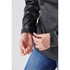 A close-up of a black women's anorak jacket, highlighting the cuff detail and a hand adjusting the sleeve.
