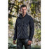 A man wearing a dark grey softshell jacket with lighter grey accents, set against a natural background.