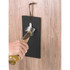 A drink bottle opener in a sleek black design mounted on a wooden surface, featuring a metallic bottle cap remover.