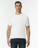 A man is wearing a plain white adult tri-blend tee with short sleeves, paired with dark blue jeans.