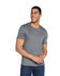 A grey adult tri-blend tee worn by a smiling man, featuring a logo on the shirt.