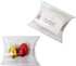 A pillow pack containing two mini solid Easter eggs, one red and one gold, with a logo on the packaging.