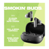 A pair of grey Skullcandy Smokin' Buds earbuds in their charging case on a bright green background.