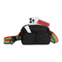 A black fanny pack features a rainbow strap, holding a phone, a notebook, and a small tube.