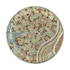 A circular decorative item featuring a complex dot painting design in earthy tones of red, brown, and cream, with blue accents.