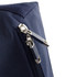 A navy blue zipper close-up on a textured fabric, featuring silver metal zipper pulls and a stitching detail.