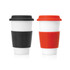 A set of two ceramic travel mugs, one black and one orange, both with removable silicone sleeves and lids.
