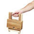 A hand holding a foldable cheese and wine board made of wooden materials in natural tones. The product has a logo.