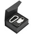 A black gift box containing a silver multi-tool with a carabiner clip. The interior features a soft black foam lining.
