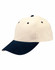A suede peak cap in cream and navy, featuring a curved brim and ventilation holes. It includes a logo.