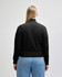 A black women's full-zip jacket made of French terry fabric, featuring a logo.