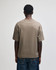 A unisex heavyweight cotton boxy T-shirt in a taupe colour, with a simple design and a small logo at the back.