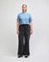 A light blue crop boxy T-shirt paired with blue jeans, worn by a model against a plain background.