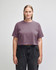 A women's cropped boxy T-shirt in a muted mauve colour, featuring short sleeves and a relaxed fit. It has a logo.
