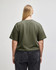 A mid-length boxy top in olive green, featuring short sleeves and a relaxed fit, with a logo present.