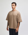 A beige oversized unisex boxy top with short sleeves and a simple design, featuring a logo.