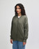A model wearing an olive green unisex bomber jacket with a zip and side pocket.