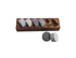 A wooden base holding six whisky discs in various shades of grey and brown, with two additional grey discs beside.