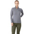 A women's grey knit quarter zip jumper featuring a logo on the chest, paired with green pants.