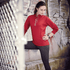 A red knitted quarter zip jumper for women, featuring a side logo, styled with grey leggings.