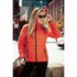 An orange puffer jacket worn by a woman, featuring zippered pockets and a sleek design, set against an urban background.