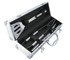 A BBQ set in a silver case, featuring a spatula, tongs, and a fork, with black accents.