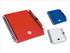 A red notepad with a pen, spiral-bound, alongside blue and white variants, featuring a logo.