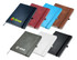 A collection of Apex A5 notebooks in various colours including black, white, brown, blue, red, and green, with logos.