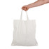 A hand holding a white short handle bamboo tote bag. The bag features two sturdy handles.