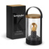 A black and clear glass lantern with a wooden lid, displayed alongside its packaging. Features a warm light bulb inside.